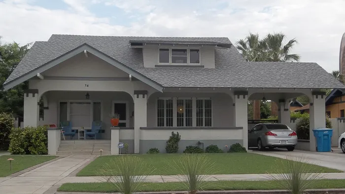 Gray Roosevelt Craftsman bungalow with low gable and front porch