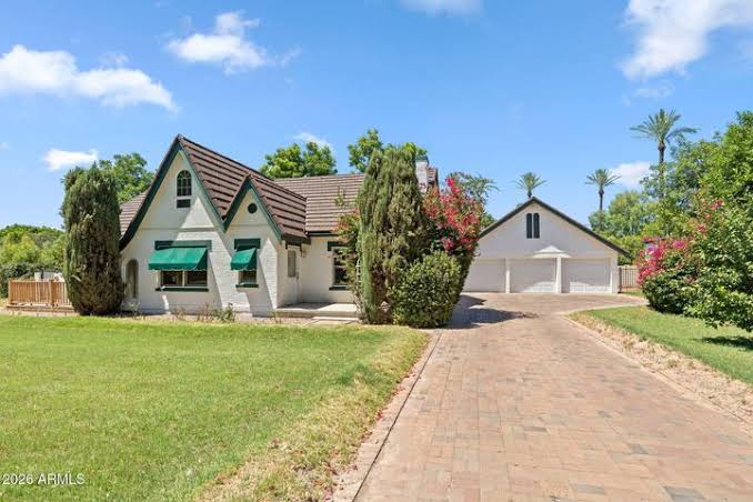 English cottage influenced Windsor Square home with steep front gables and green awnings