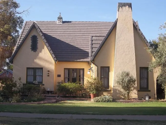 Tudor Revival home with steep front gables and prominent chimney