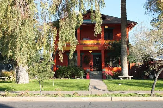 Two-story house with a deep shaded porch and contrasting trim