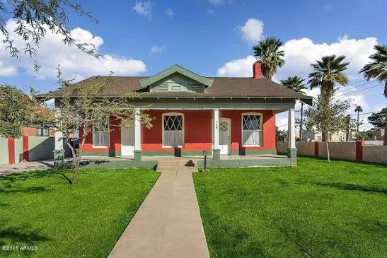 One-story bungalow with a generous front porch, tapered supports and a roof dormer