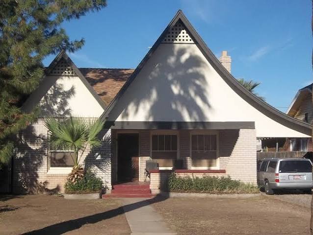 Coronado cottage with steep twin front gables and inset porch