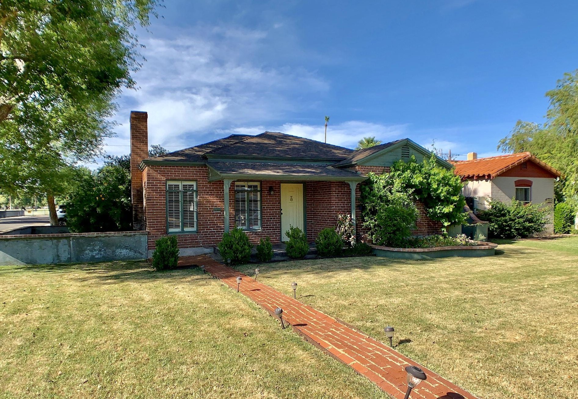 One-story brick house with hipped roof and small covered porch