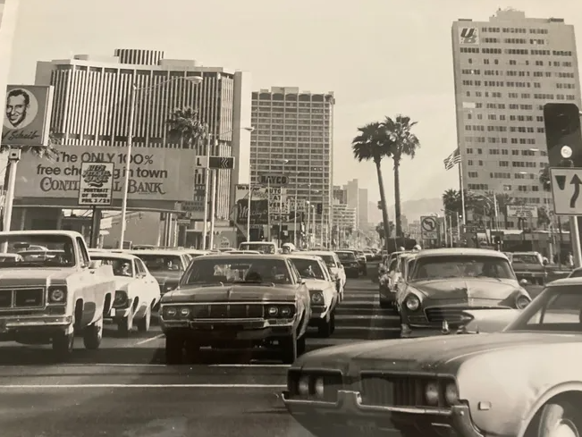 Historic Phoenix street scene with mid-century automobiles and commercial buildings