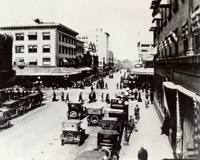 Historic photograph of a busy Phoenix downtown street with automobiles