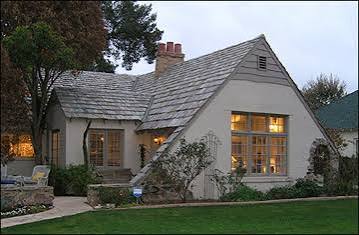 Willo cottage with steep gables, stucco exterior and multi pane windows