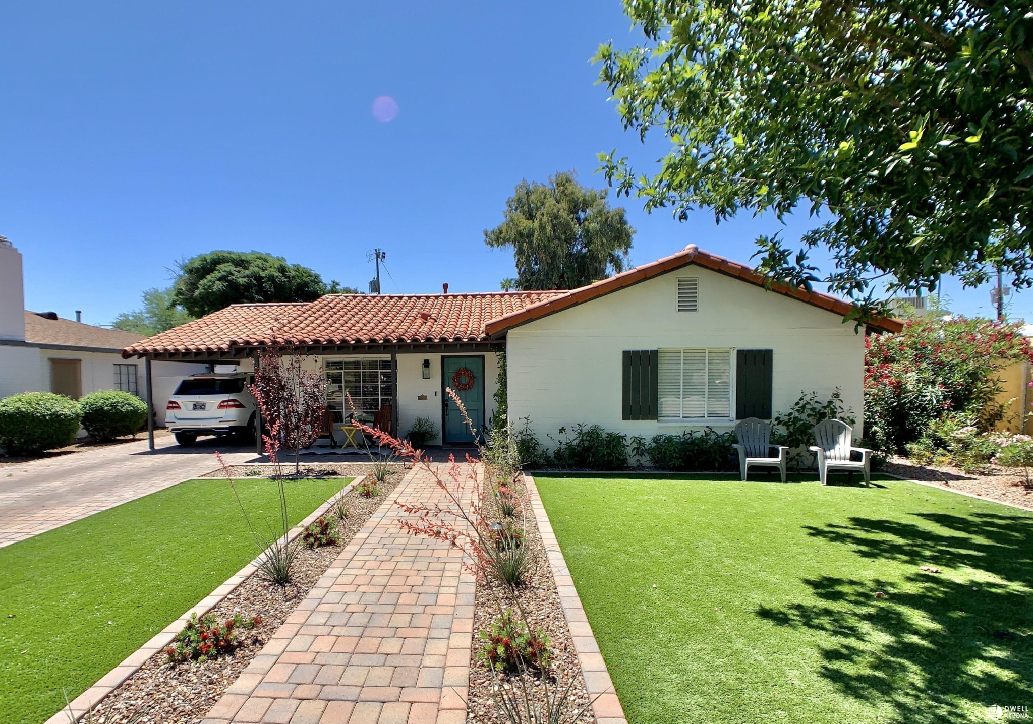 Single-story Windsor Square home with red tile roof, broad lawn and brick walkway