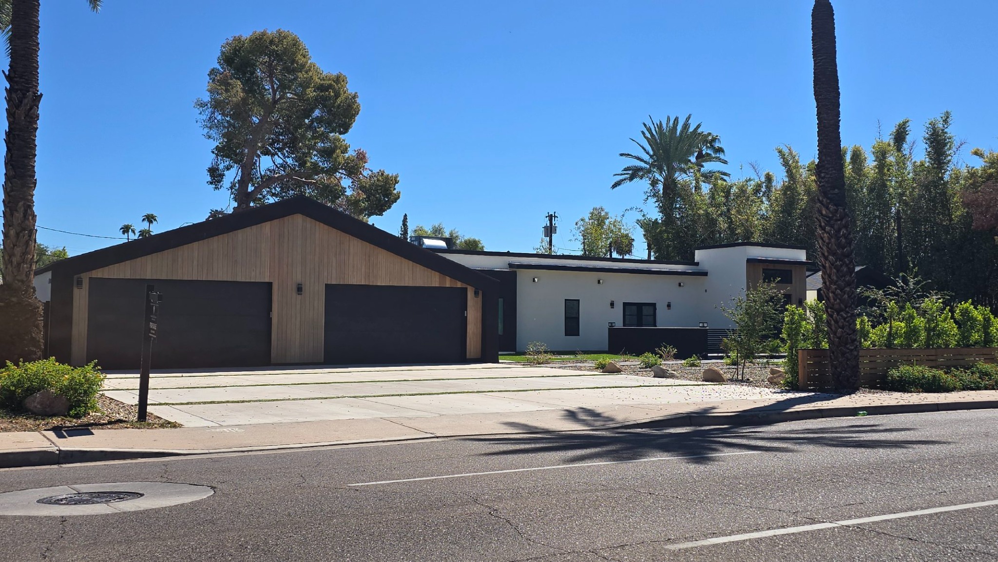 Home for sale in Scottsdale, with two garage bays and palm trees